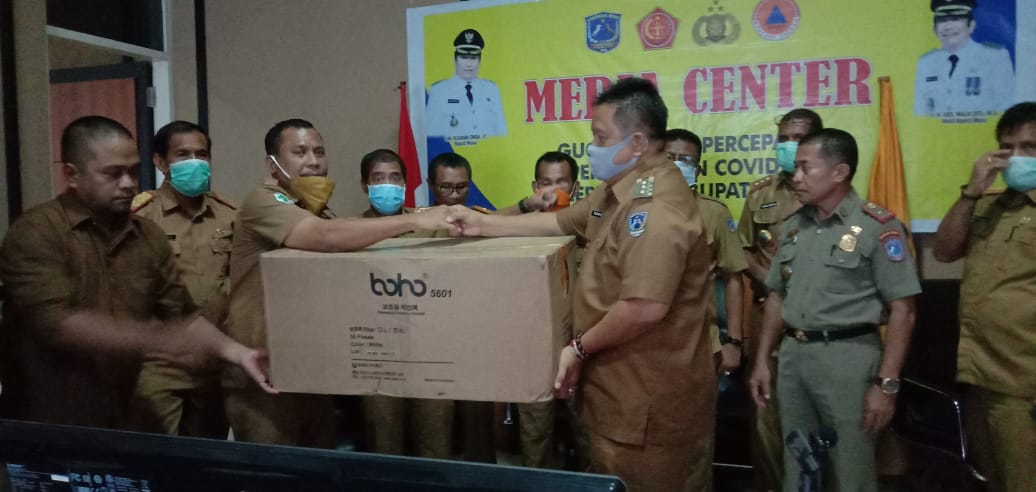 Bupati Muna, LM Rusman Emba menyerahkan APD pada Direktur RS, Dr Muhamad Marlin. Foto : Naryo/Telisik