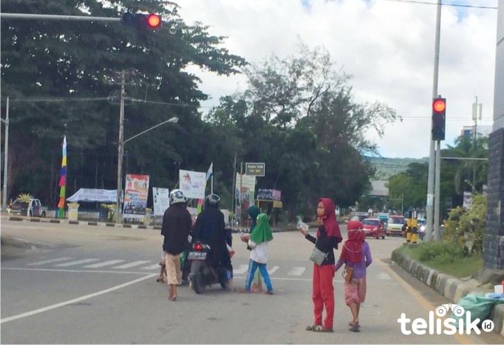 Pengamen jalanan di lampu merah depan Kantor Diknas Provinsi Sultra. Foto: Dul/Telisik