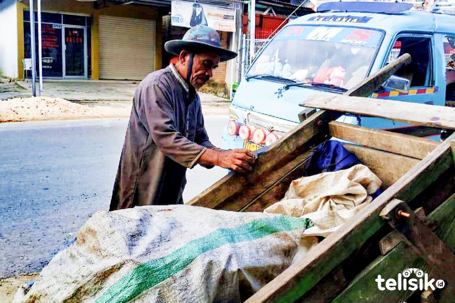 La Ode Tolu sedang memperbaiki gerobaknya. Foto : Wahyu Pratama/Telisik