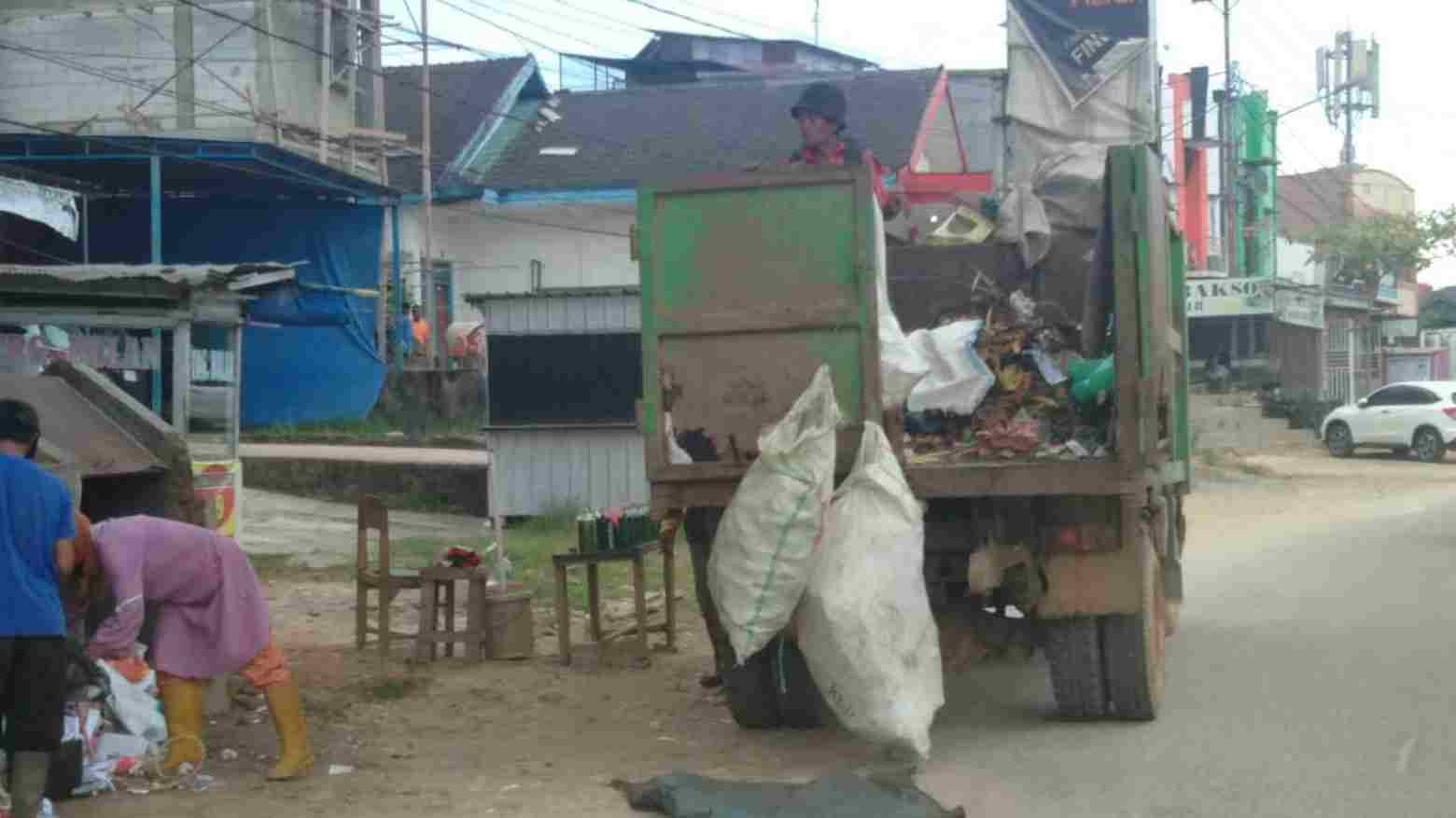 Petugas sedang mengangkut sampah di TPS. Foto: Ist.