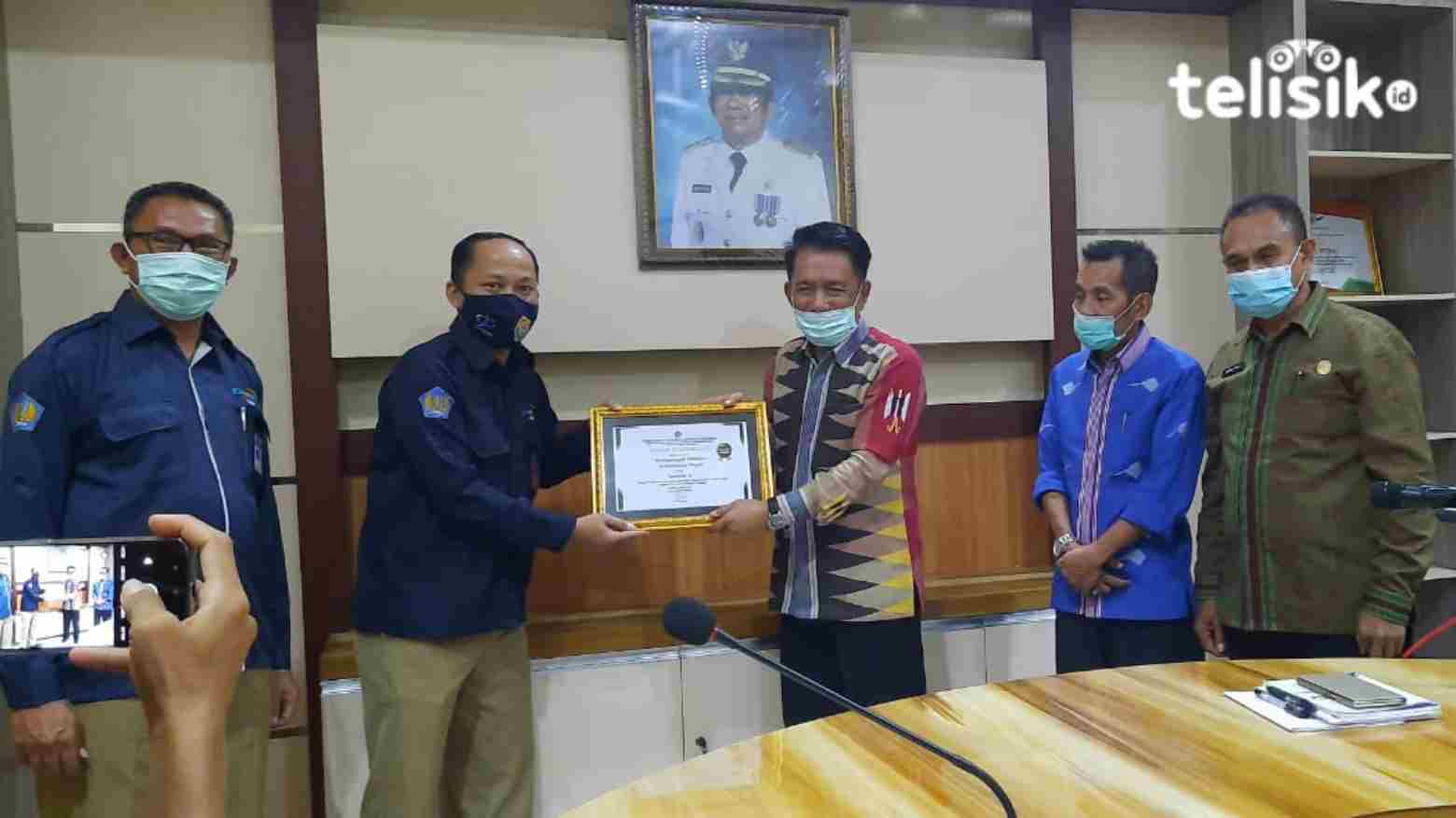 Wakil Bupati Muna, Abdul Malik Ditu menerima piagam penghargaan dari Kepala KPPN Raha, Sulistiyono. Foto: Sunaryo/Telisik