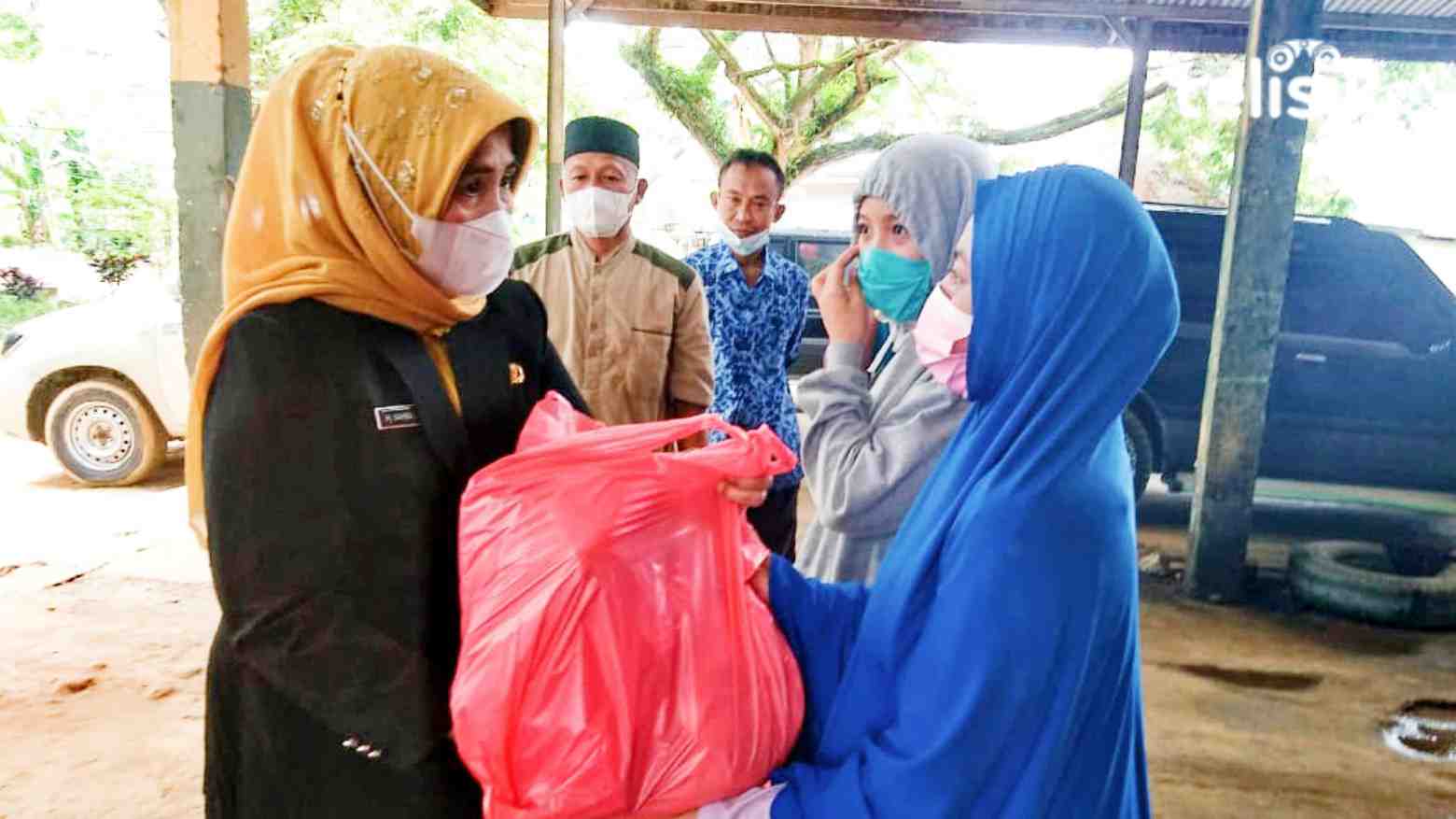 Sekda Kota Kendari, Nahwa Umar (kiri) saat menyerahkan paket sembako. Foto: Fitrah Nugraha/Telisik
