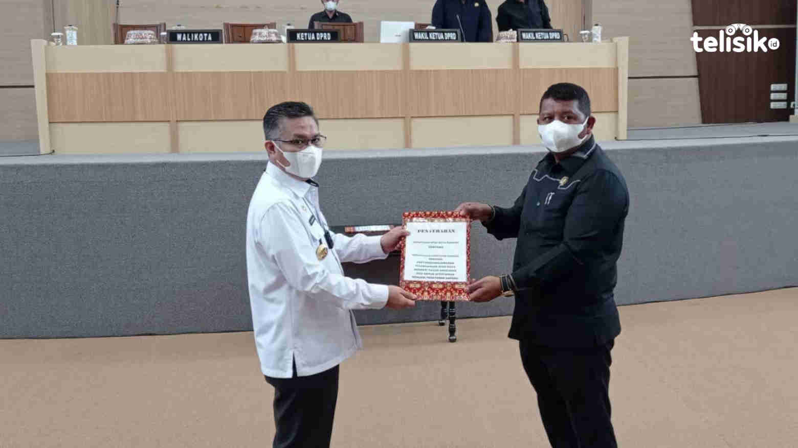 Wali Kota Kendari, Sulkarnain (kiri), menyerahkan berita acara penetapan Raperda pada Ketua DPRD Kendari, Subhan (kanan). Foto: Sumarlin/Telisik