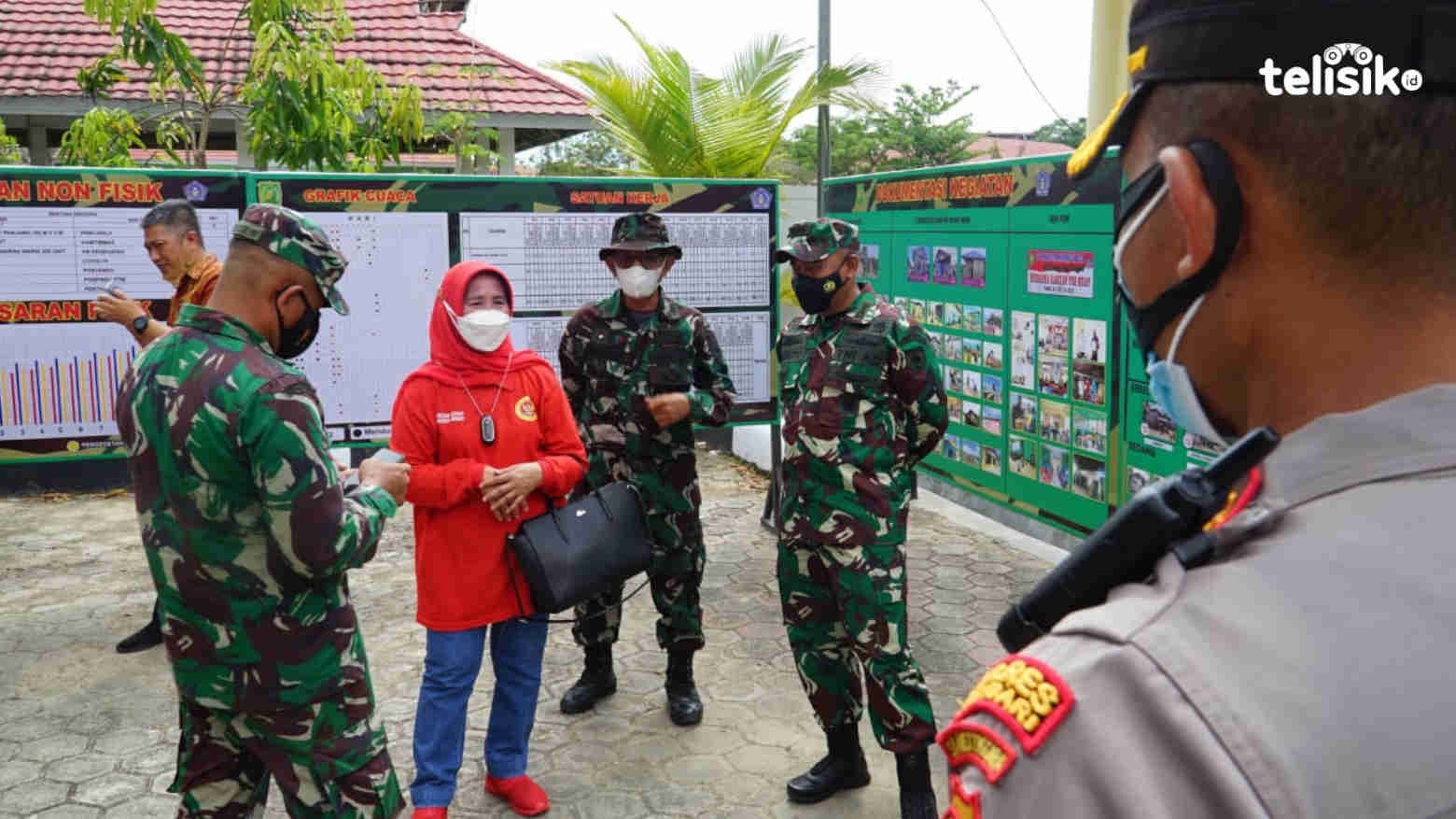 Sekda Kota Kendari Nahwa Umar (baju merah) bersama TNI Polri saat melihat dokumentasi kegiatan TNI Manunggal Masuk Desa (TMMD). Foto: Sumarlin/Telisik
