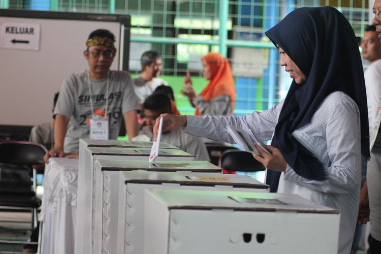 Salah seorang pemilih yang sedang memasukkan surat suara kedalam kotak suara sesuai melakukan pencoblosan. Foto: Repro Kompas.com