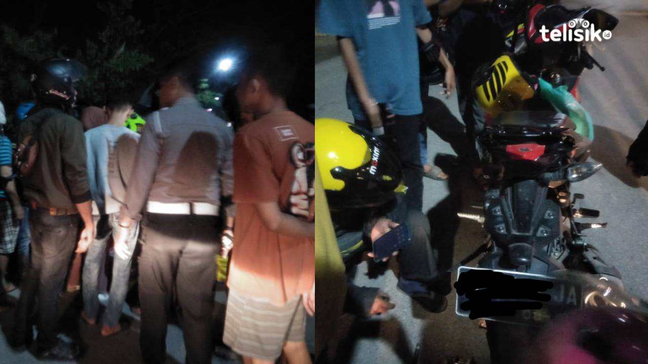 Warga yang berkumpul dan berusaha membantu pengemudi ojol ke pinggir jalan, usai rok penumpang tergilas rantai. Foto: Thamrin Dalby/Telisik