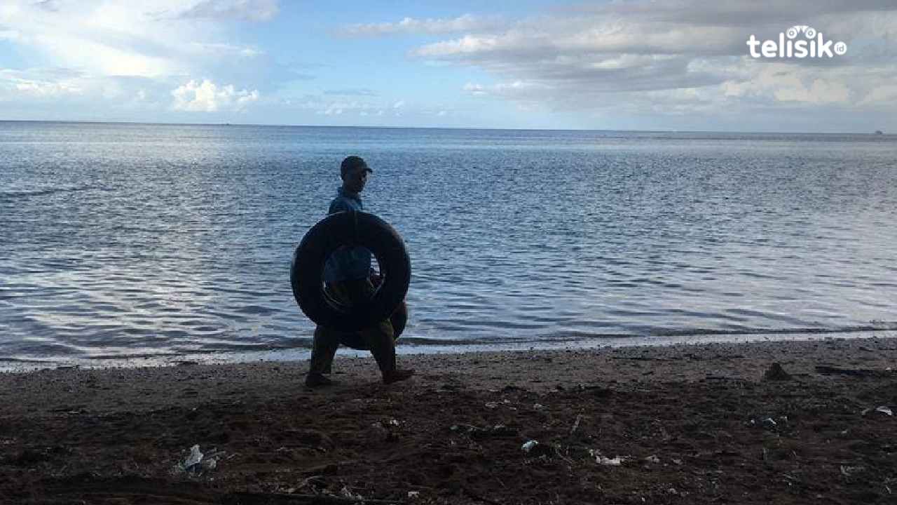Salah seorang pengelola Pantai Tanjung Tabako yang sedang membawa ban pelampung untuk disewakan. Foto: Ahmad Badaruddin/Telisik