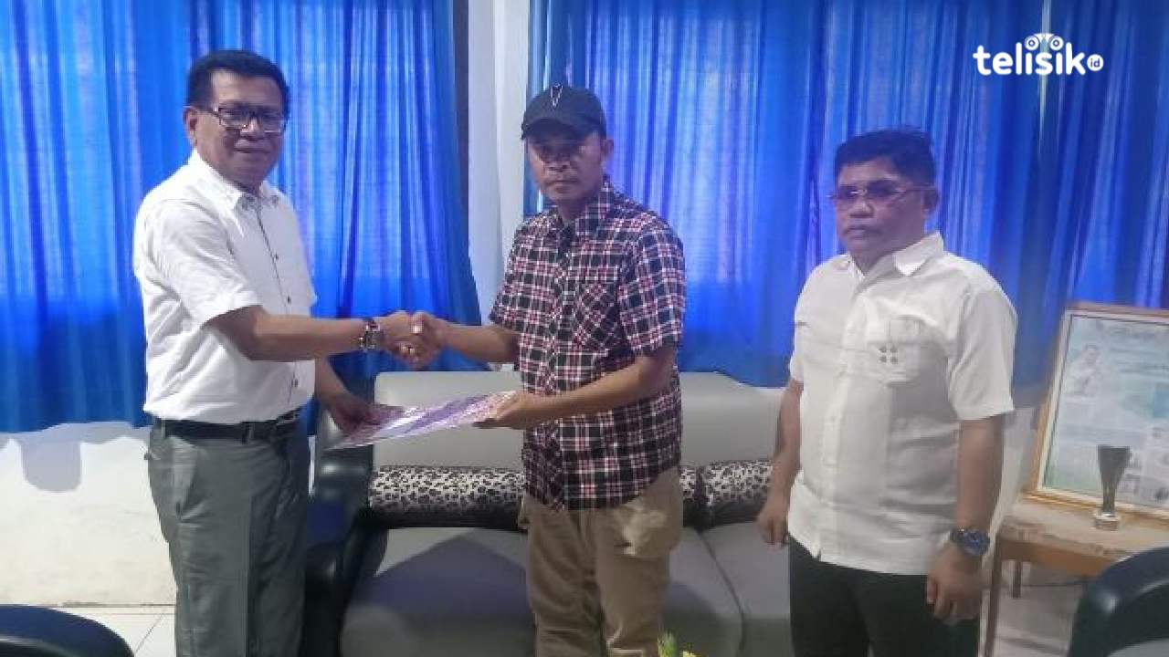 Kadis PMD Muna, Fajaruddin Wunanto menyerahkan SK Pj kades Wadolao ke cCmat Marobo. Foto: Sunaryo/Telisik