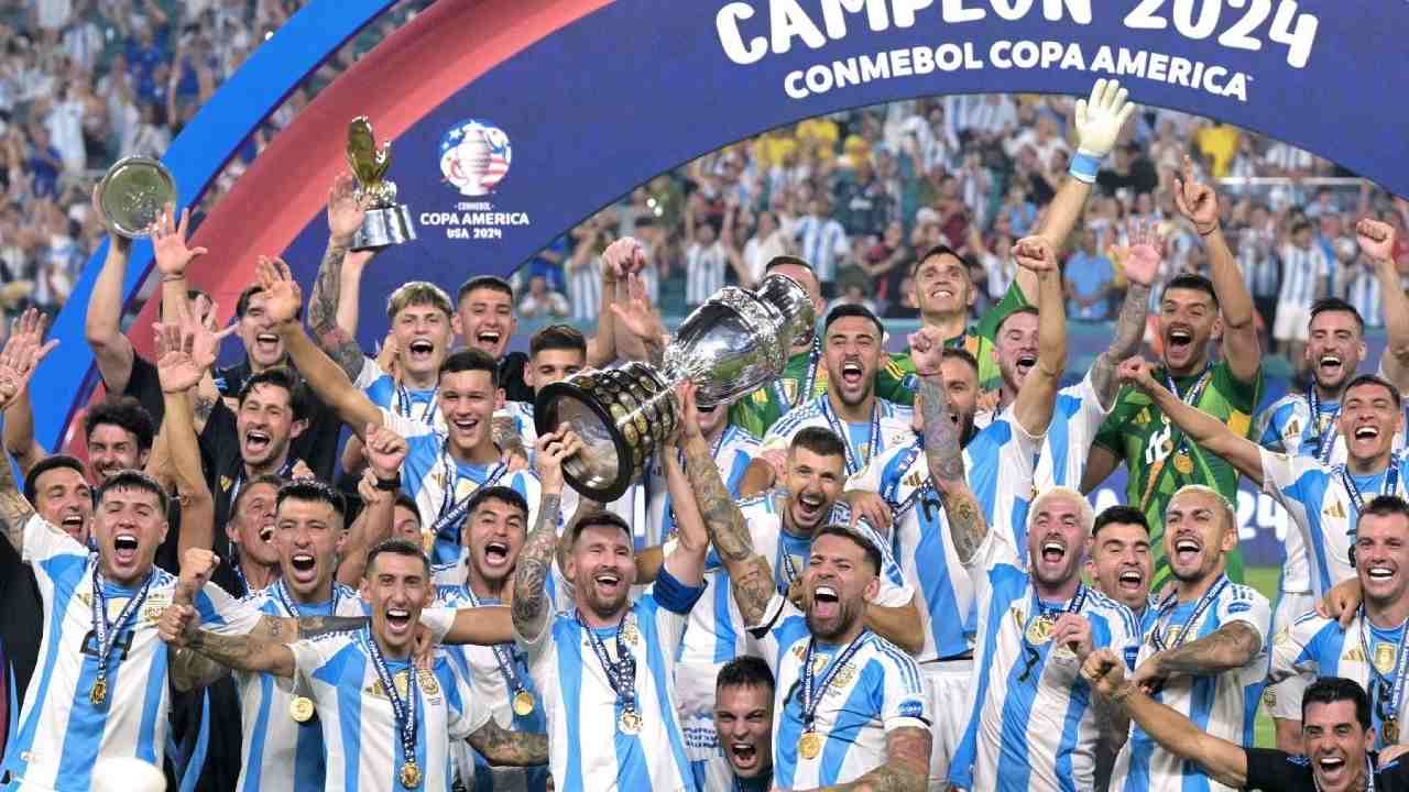 Kapten Argentina, Lionel Messi, memegang trofi dan merayakan kemenangan tim usai pertandingan Final Copa America 2024 CONMEBOL melawan Kolombia di Stadion Hard Rock, Miami Gardens, Florida, Senin (15/7/2024) pagi WIB. Foto: Buda Mendes/AFP
