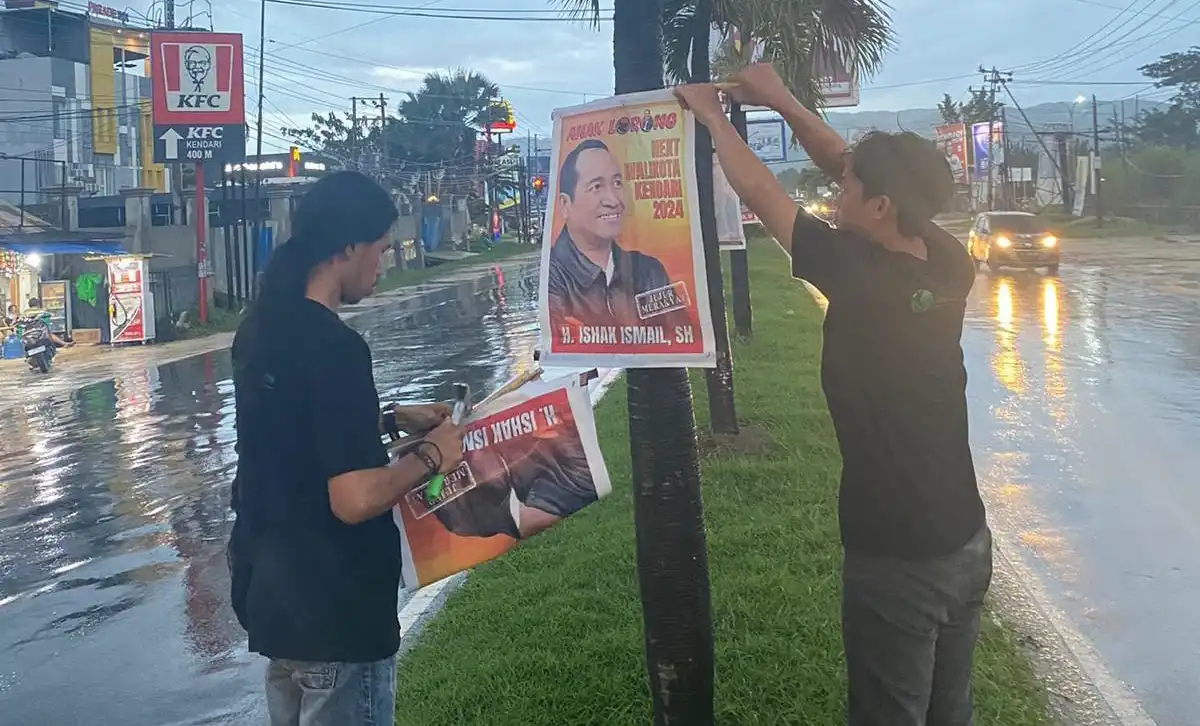 Lembaga pemerhati lingkungan Kota Kendari mencopot poster bakal calon Wali Kota Kendari, Ishak Ismail. Foto: Ist.