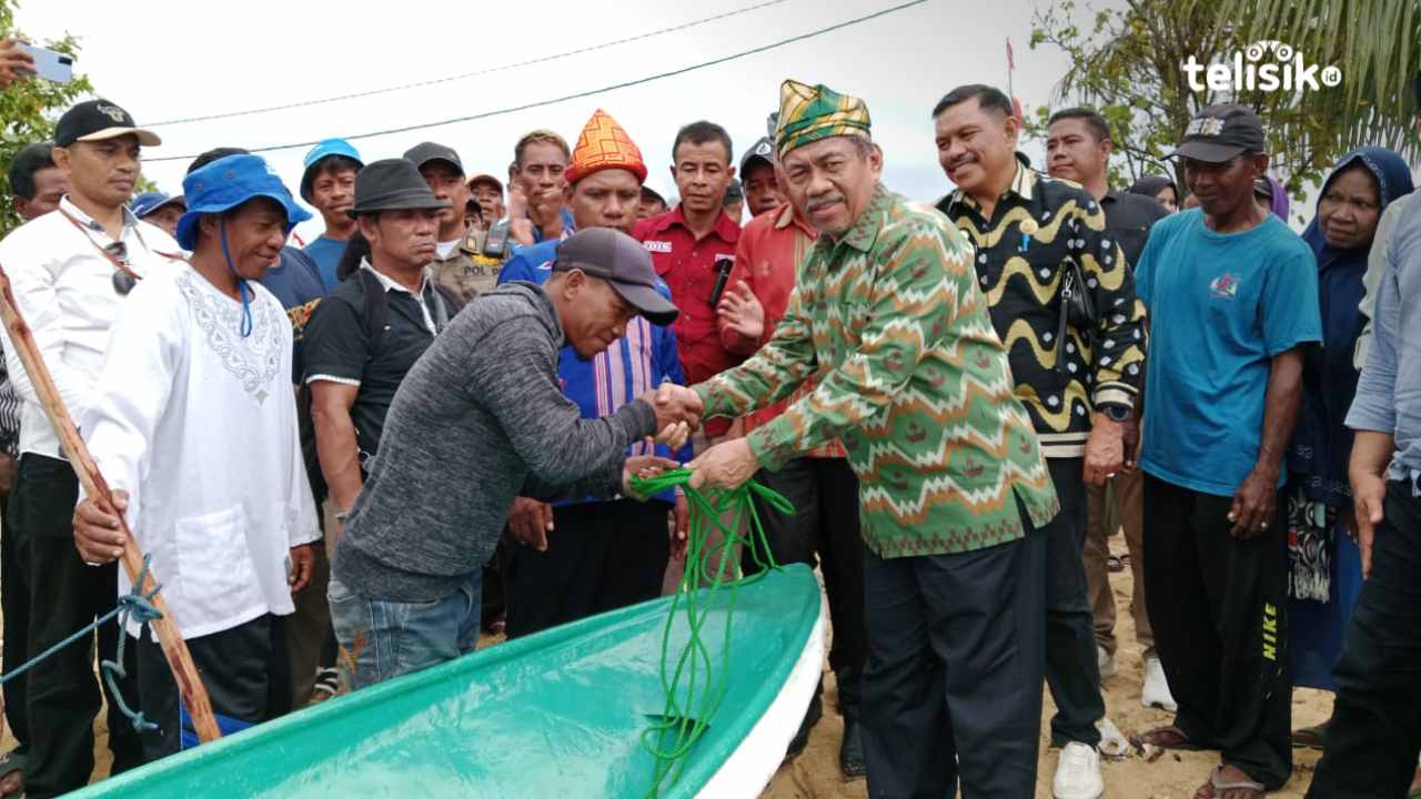 Plt Bupati Muna, Bachrun Labuta menyerahkan bantuan perahu fiber ke nelayan Desa Renda. Foto : Sunaryo/Telisik