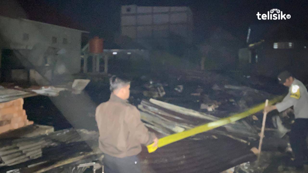 Aparat kepolisian saat memasang garis polisi di lokasi kebakaran. Foto: Sunaryo/Telisik