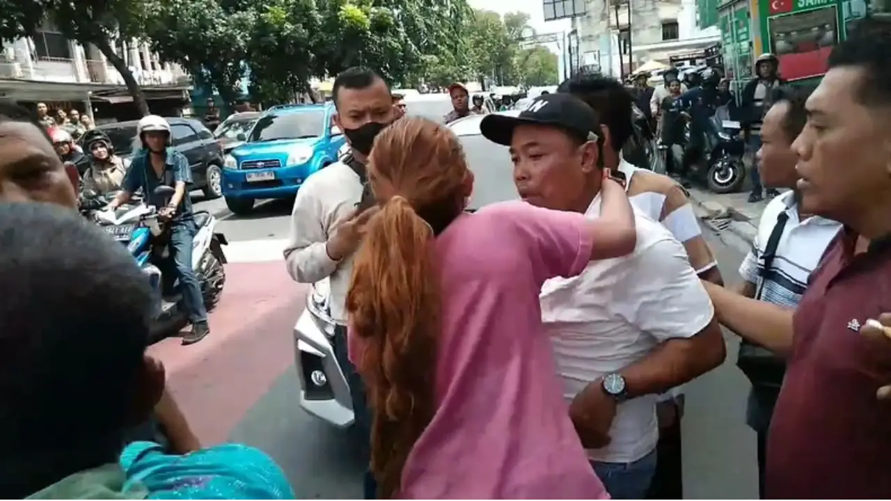 Seorang wanita terlihat baku hantam dengan dua debt collector. Foto: Repro OkezoneNews.