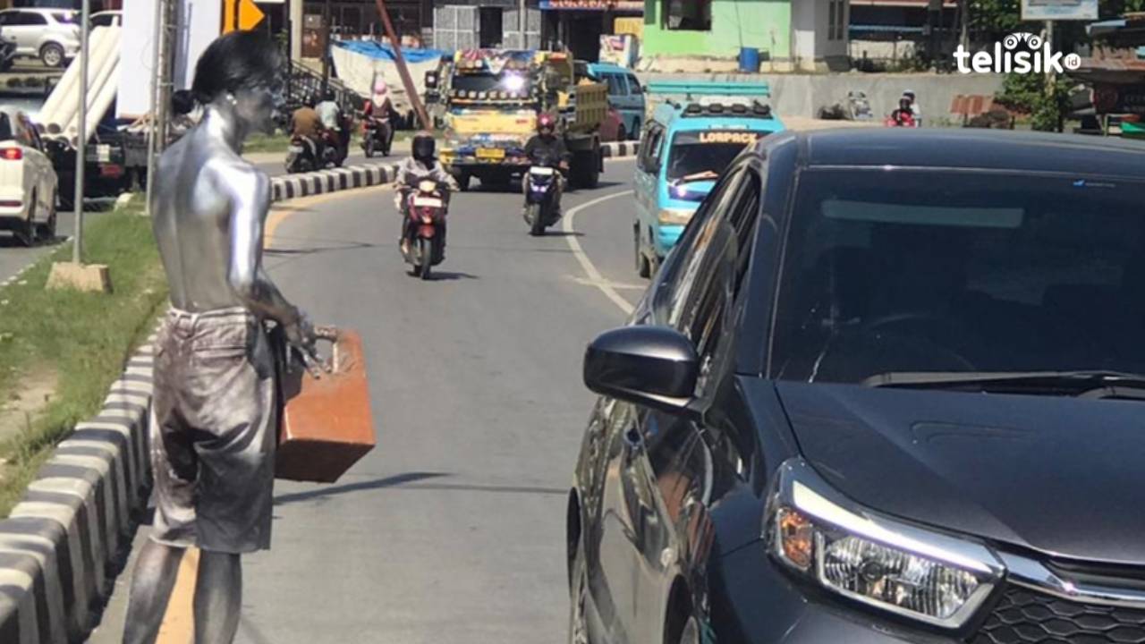 Sosok Arman, Si manusia silver yang mencari nafkah di pinggir jalan perempatan lampu merah Kota Kendari. Foto: Gusti Kahar/Telisik